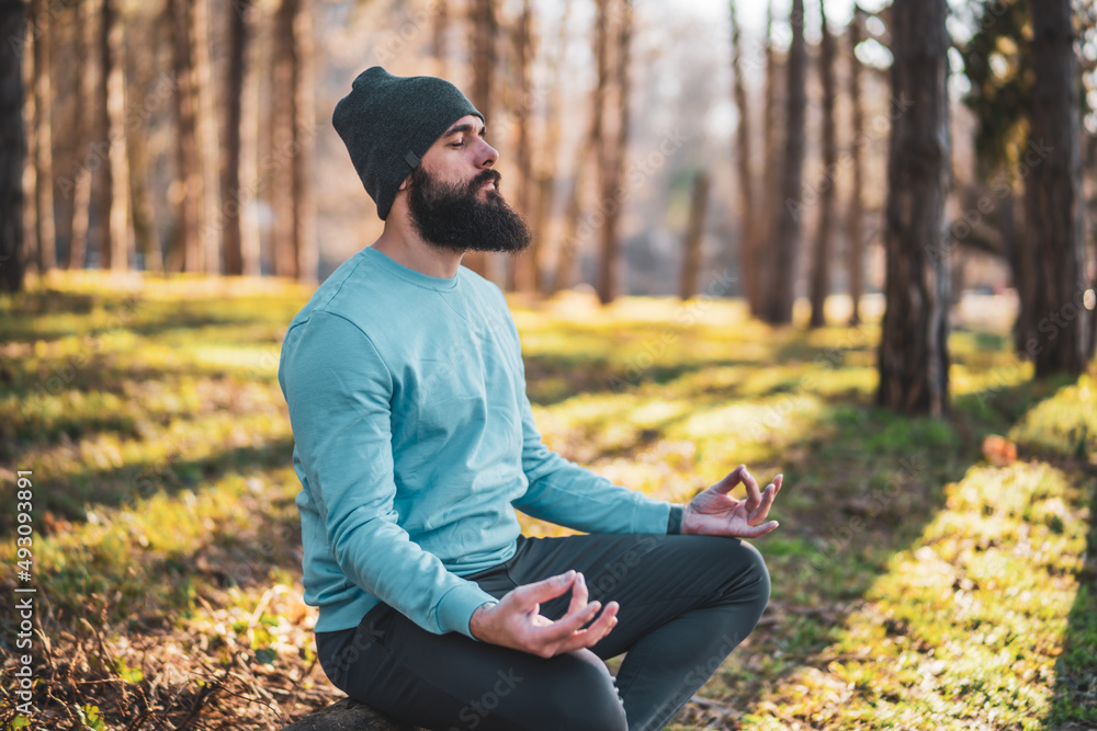 Sporty man enjoys meditating in the nature. Sporty man enjoys meditating in the nature.