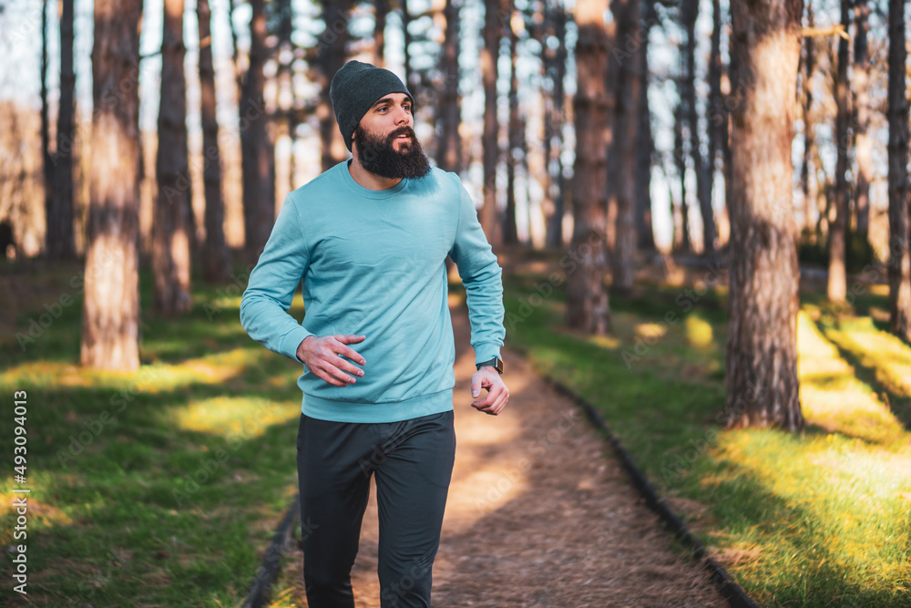 Man with beard enjoys jogging in nature. Man with beard enjoys jogging in nature.