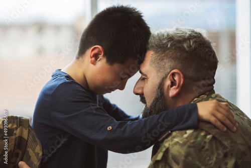 Soldier welcoming his son at home - family concepts in war -