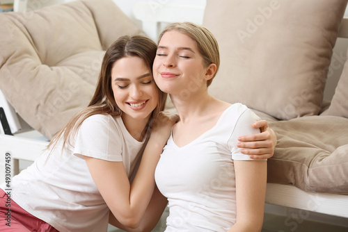 Young sisters spending time together at home