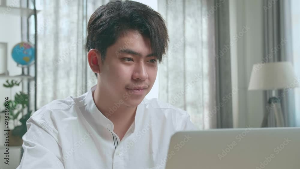 Close Up Of A Happy Asian Man Student Using Computer To Study Online At Home
Close Up Of A Happy Asian Man Student Using Computer To Study Online At Home