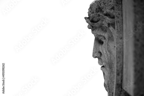 Jesus Christ in a crown. Fragment of an ancient statue isolated on white background. Copy space.