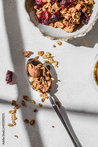 granola in a spoon on a light background photo