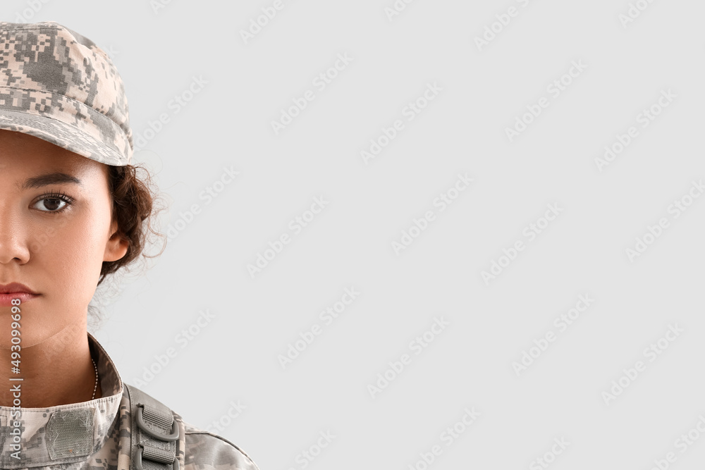 African-American female soldier on light background African-American female soldier on light background