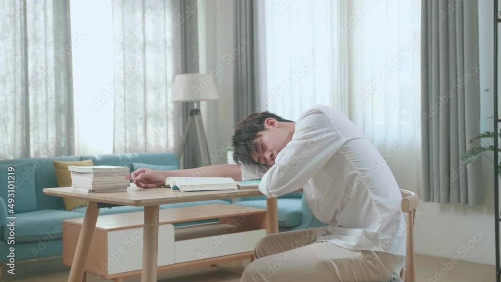 Side View Of Asian Man Student Sleeping While Studying At Home
Side View Of Asian Man Student Sleeping While Studying At Home