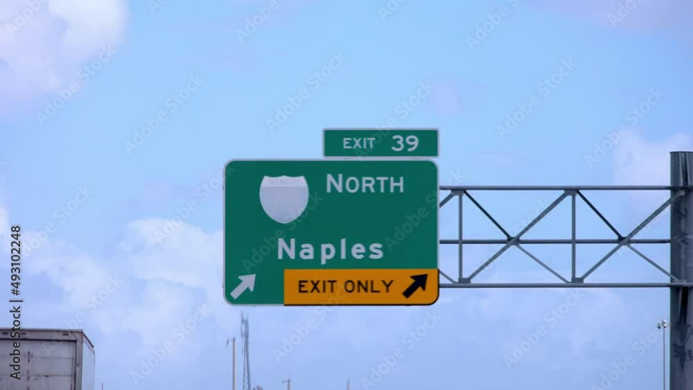 Street sign on the highway of Florida showing Naples - travel photography Street sign on the highway of Florida showing Naples - travel photography