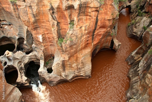 Bourke's Luck Potholes, Blyde River Canyon view to red rock formations with brown water river and some potholes