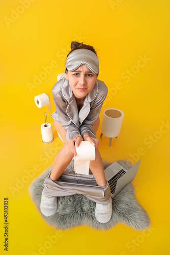 Young woman in pajamas suff...