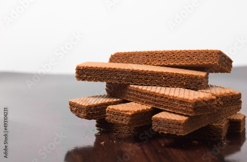 Pile of delicious chocolate wafers, on white background. photo