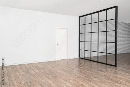 View of big empty room with door and folding screen