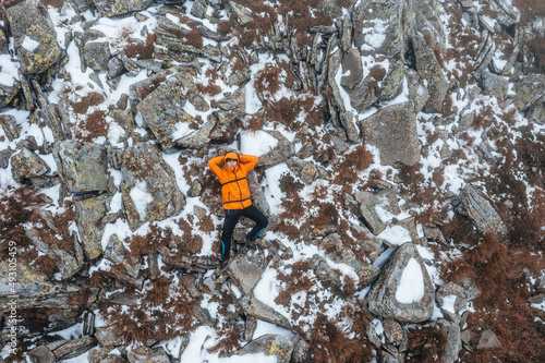 The tourist is lying on a rock near Mount Petros