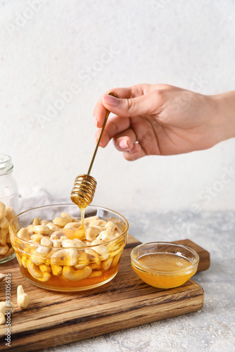Hand drizzling golden honey...