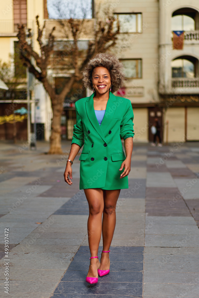 Portrait of attractive positive curly hairstyle dark skin lady smile free time outdoors Portrait of attractive positive curly hairstyle dark skin lady smile free time outdoors