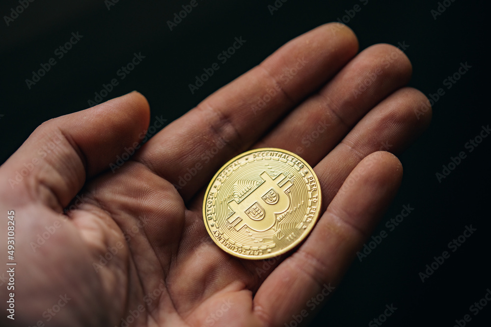 Fototapeta premium Silver bitcoin cryptocurrency in a hand