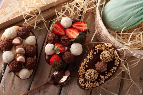 
homemade easter egg with chocolate, strawberry, brigadeiro and nest milk photo