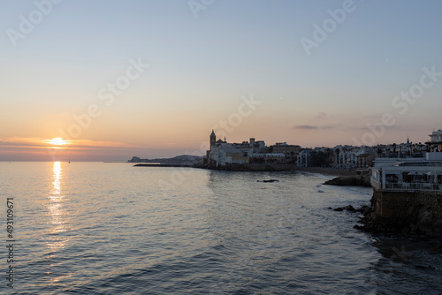 Picturesque sea evening landscape. Sunset over the mediterranean sea. Evening city, sea and sunset. The sun is above the horizon line. © Sergei