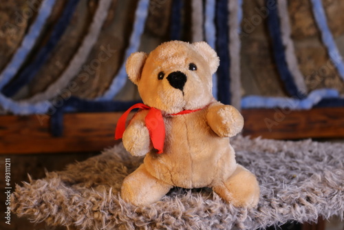 Fotografie Brown teddy bear with cool red tie
