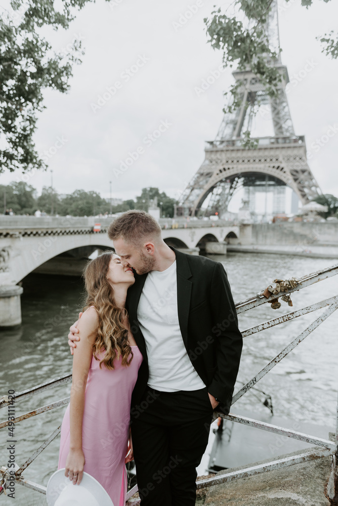 Bride and groom are walking in Paris near the Eiffel Tower