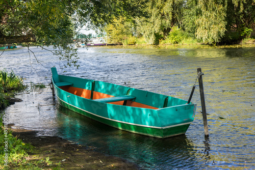 Rowing boat floating over the Lake. Fishing lake in early summer.