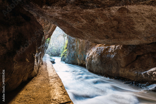 Exit from the cave between mountains on the route of the Monachil river, in Los Cahorros, Granada, Spain.