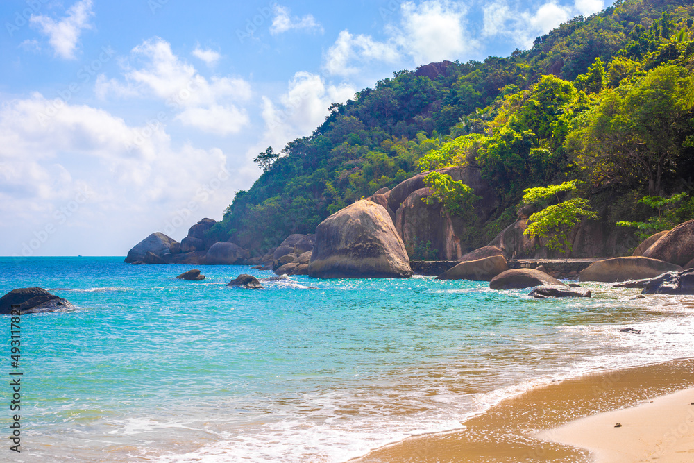 Seascape. Rocky seashore with tropical forest on the mountain. Beach holidays in Thailand