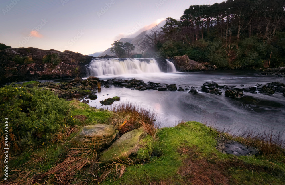 Beautiful nature scenery with waterfall on river Erriff with mountains in the background at Aesleagh, county Mayo, Ireland