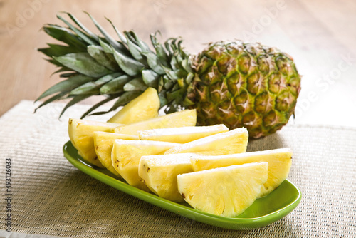 Pineapple slices with leaves. Cut pineapple on a plate