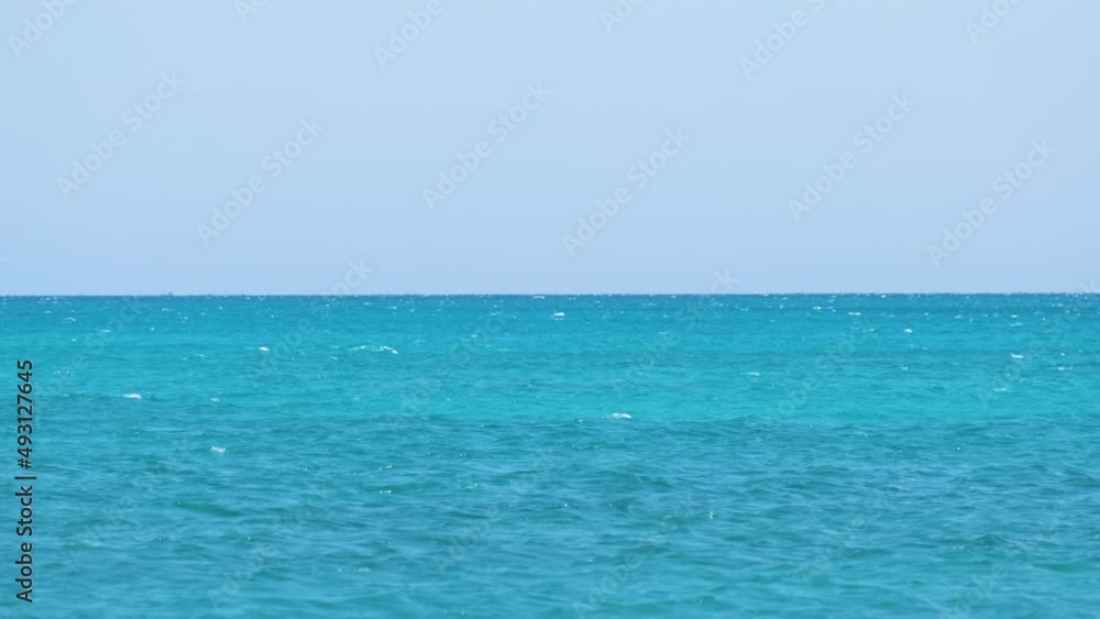 Closeup seascape surface of blue sea water with small ripple waves Closeup seascape surface of blue sea water with small ripple waves