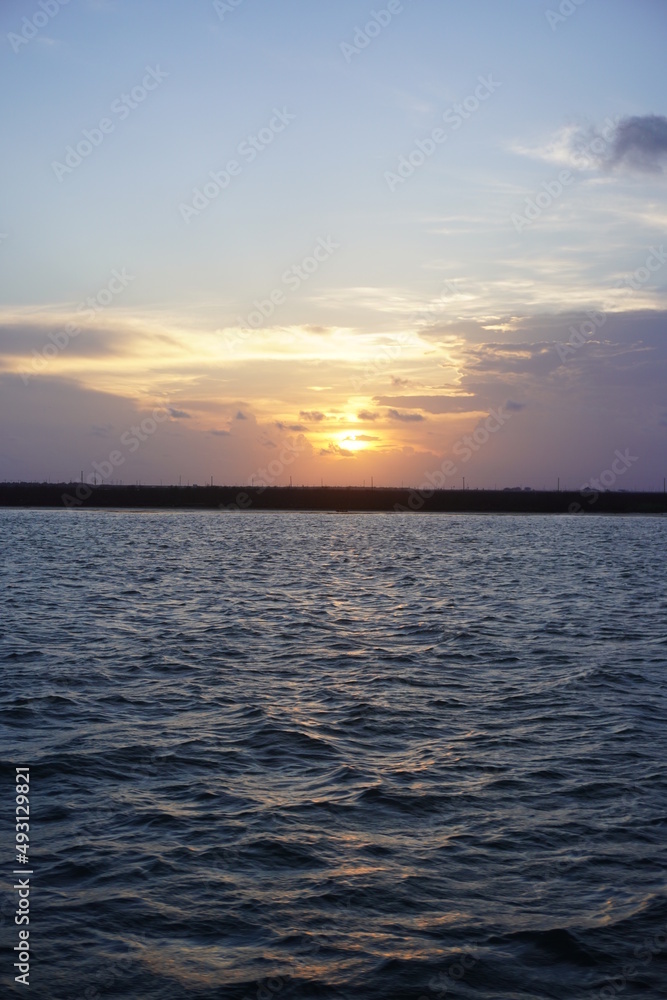 This is a landscape picture of the marshlands around a Texas bay, at sunset.