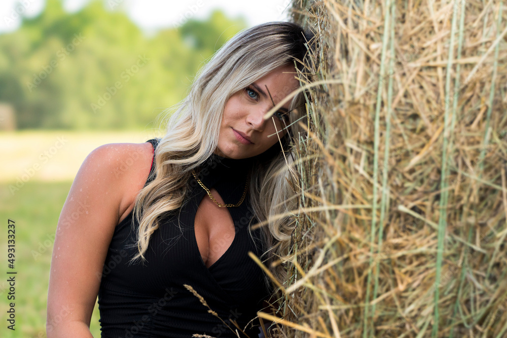A Lovely Blonde Model Poses Outdoors In A Farm Environment