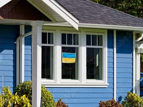 Banner with Ukrainian flag decorating the house in sign of support of Ukraine 