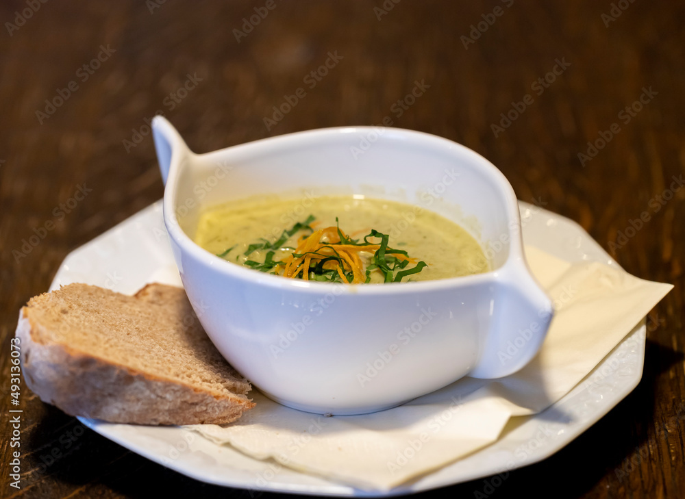Wild garlic foam soup cream soup in white bowl for restaurant or cafe Wild garlic foam soup cream soup in white bowl for restaurant or cafe