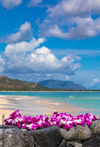 Fresh Lei Flowers Necklace on the beach, Kauai Hawaiian Island Tropical Vacation Background. Hawaii Luau Icon Travel Concept. Selective focus.