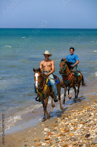 Two men horseback riding on the beach, at the beach, Margarita Island, Venezuela.