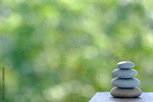 Tower, stack of pebbles in an unstable state, pyramid made of flat stones, rocky hiking trail in forest, concept tourist walk in nature, harmony and balance, zen in life, nature conservation
