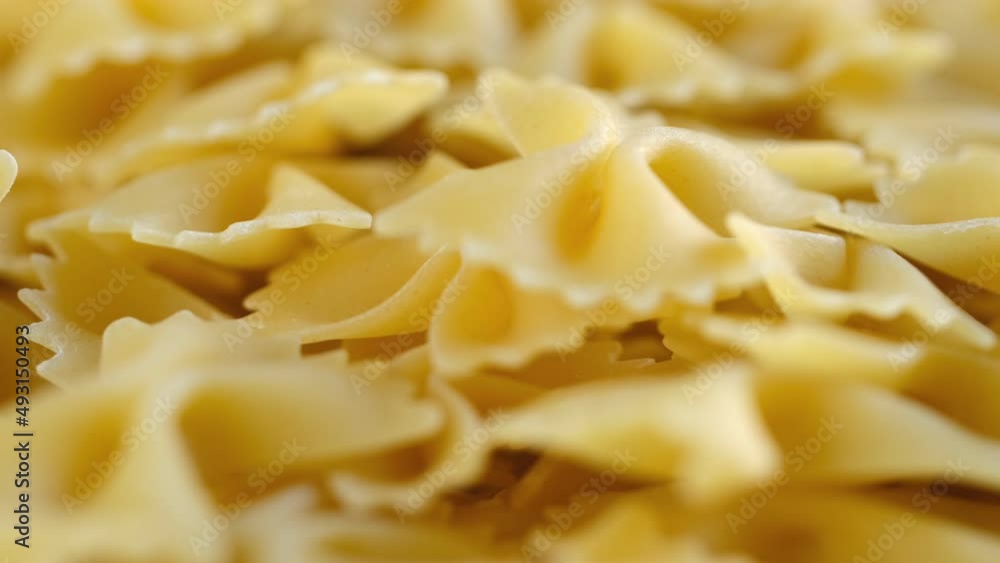 Rotating uncooked pasta . Stack of traditional dry raw macaroni. Nobody Rotating uncooked pasta . Stack of traditional dry raw macaroni. Nobody