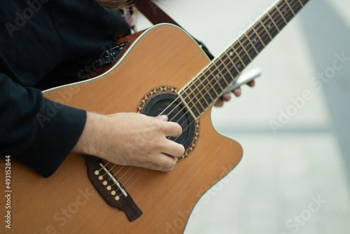 Obraz na plátně Guitar on street. Street musician plays acoustic guitar.