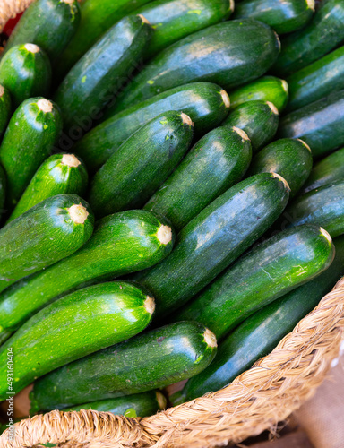 View of zucchini in a wicker basket, put up for sale in a store