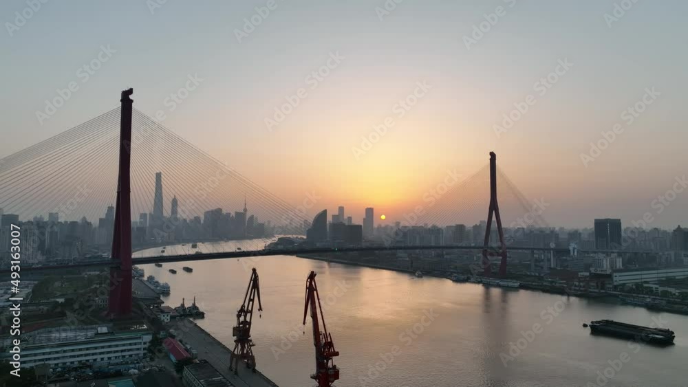 Drone aerial view of Sunset and the landmark bridge in Shanghai China. Travel, business and cityscape concept b-roll footage. The beautiful sunset in the dusk with the background of Lujiazui landmarks Drone aerial view of Sunset and the landmark bridge in Shanghai China. Travel, business and cityscape concept b-roll footage. The beautiful sunset in the dusk with the background of Lujiazui landmarks