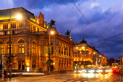 Wide shot of traffic passing the Opernring and Vienna State Opera in Vienna, Austria