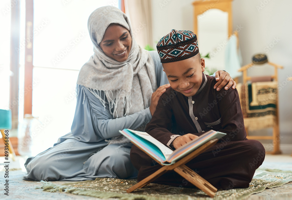 Love is the supreme form of communication. Shot of a young muslim mother and her son reading in the lounge at home. Love is the supreme form of communication. Shot of a young muslim mother and her son reading in the lounge at home.