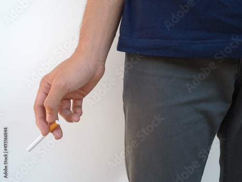 Male hand holding a cigarette. health concept.