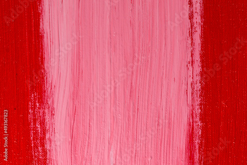 thick white acrylic paint applied in an uneven patch on a red surface