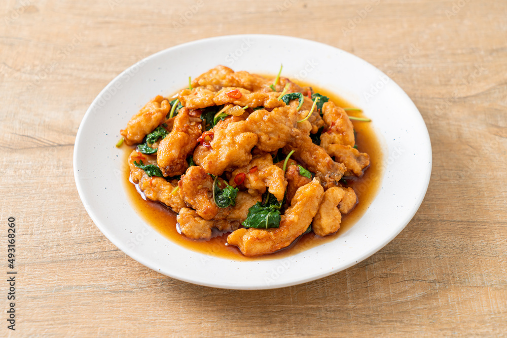 stir-fried fried fish with basil and chili in thai style stir-fried fried fish with basil and chili in thai style