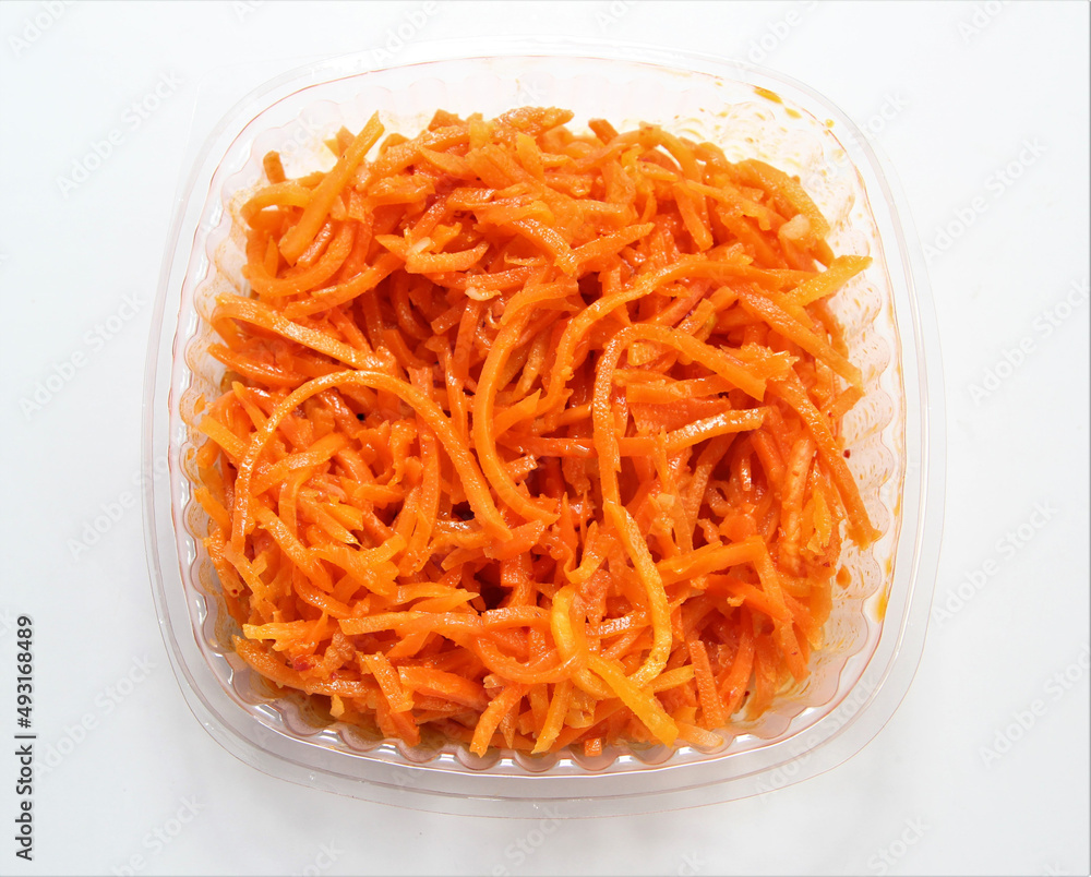 Korean Carrot Salad. Salad in a disposable bowl. Korean Carrot Salad. Salad in a disposable bowl.