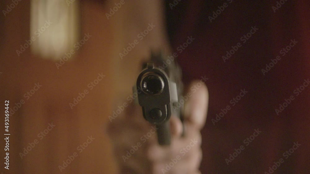 Man points a gun at the camera Man points a gun at the camera