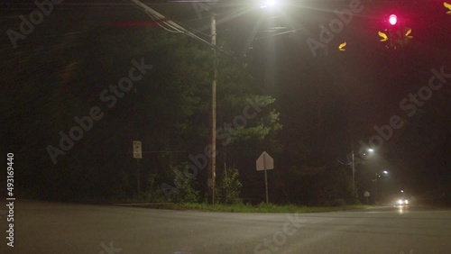 A red Nissan 240sx speeds through an intersection at night photo