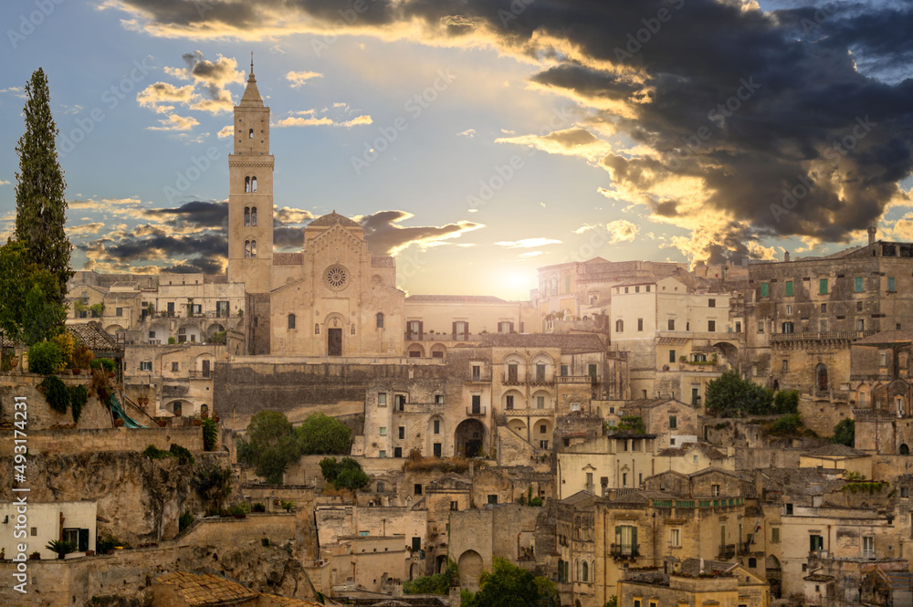 Matera, Basilicata, Italy. August 2021. The facade of the cathedral at the golden hour. Around the typical houses of the stones of Matera.