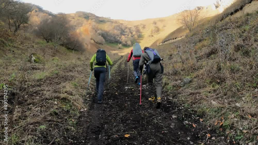 a group of people is moving through a mountainous area, the guys are hiking in the mountains a group of people is moving through a mountainous area, the guys are hiking in the mountains
