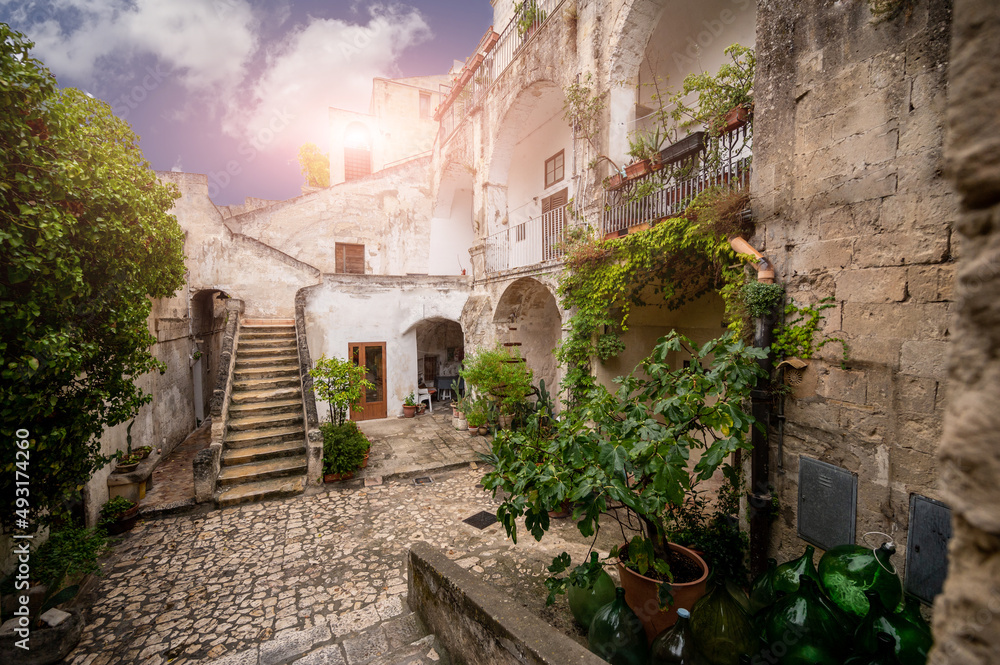 Matera, Basilicata, Italy. August 2021. View of a courtyard of houses in the historic center, built with blocks of tufa rock. Urban landscape of the stones of Matera.